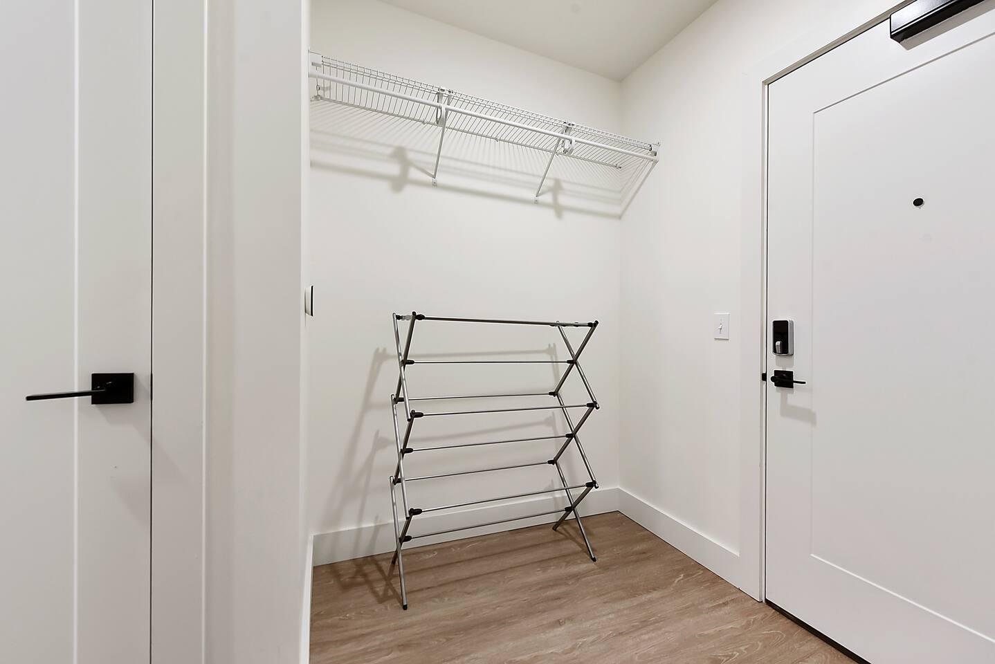 Coat hanger and a stand to dry your wet clothes behind the entrance door.