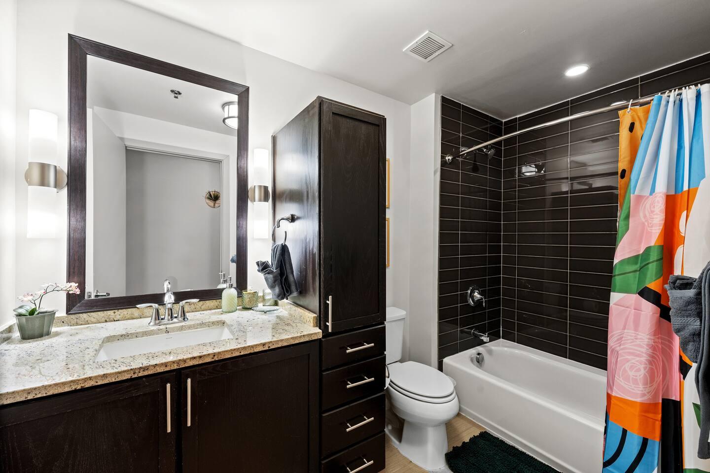 Soak and relax! ✨ Enjoy a full bathroom with a bathtub, plus complimentary shampoo, conditioner, and body wash for a spa-like experience.