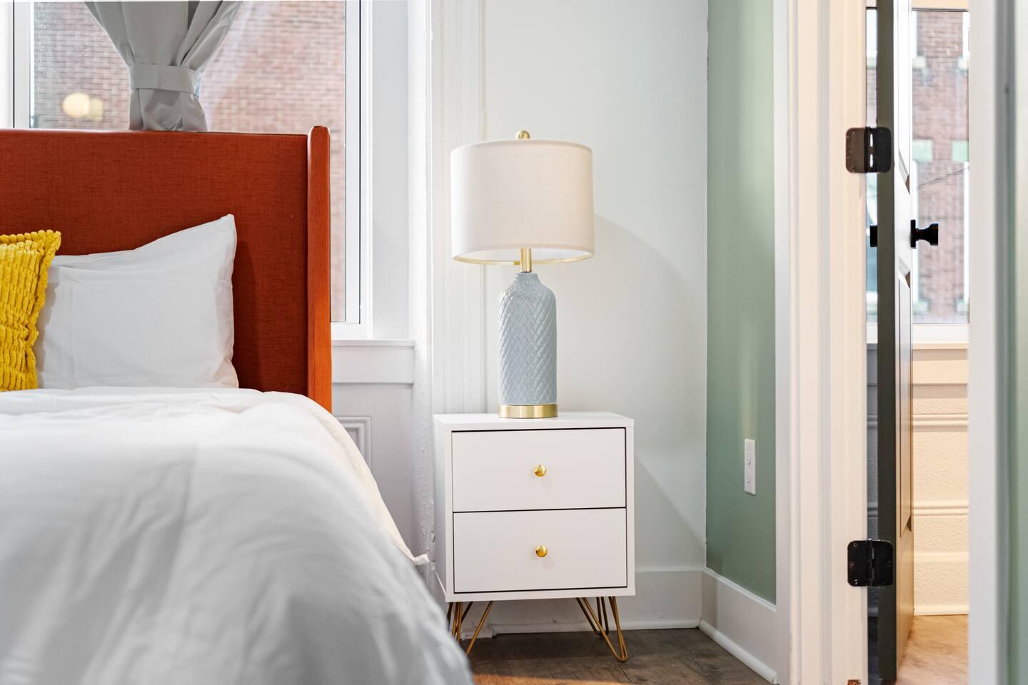 Our bedside table with a stylish lamp creates the perfect ambiance for relaxation and reading.