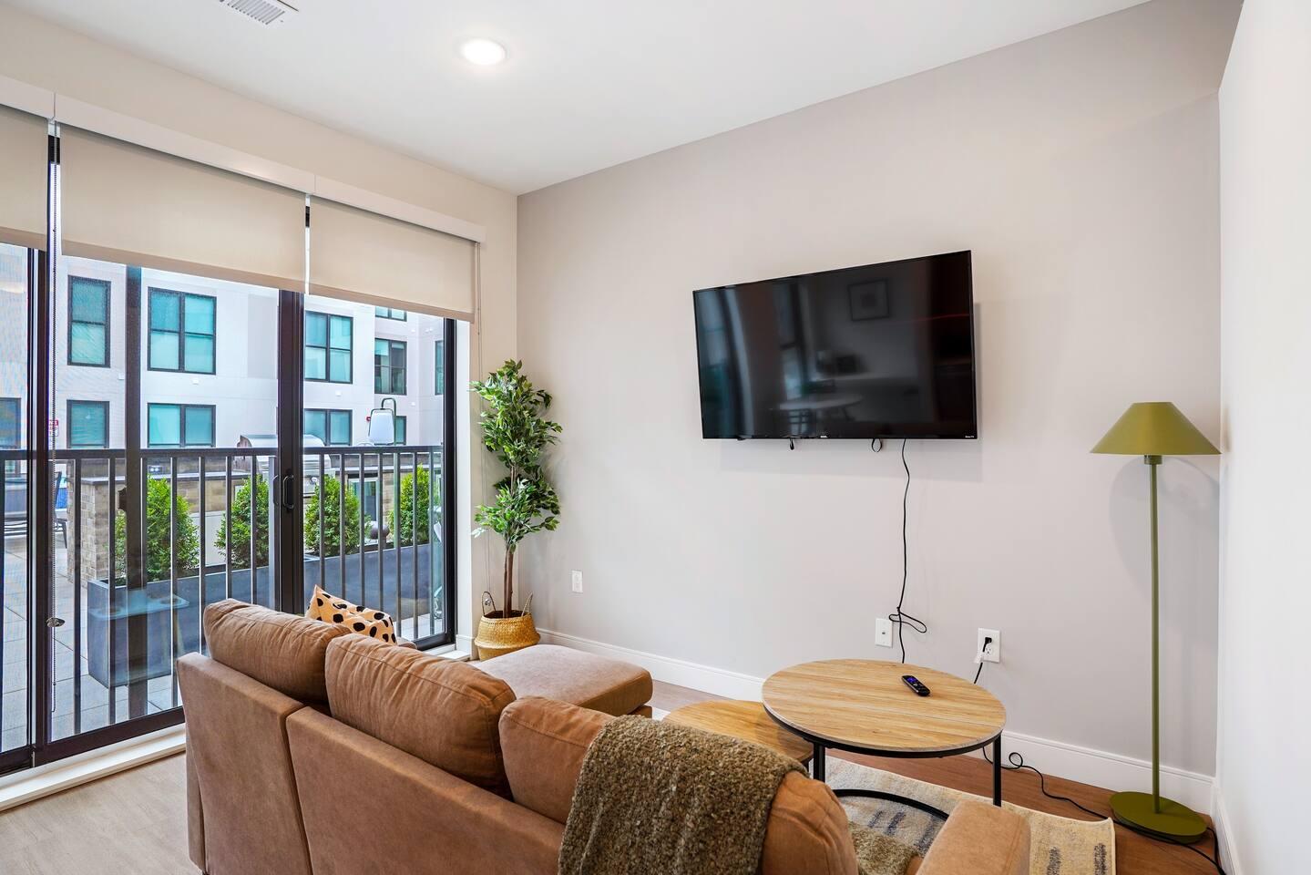 Stunning living area with comfortable couch, center table, TV and many more