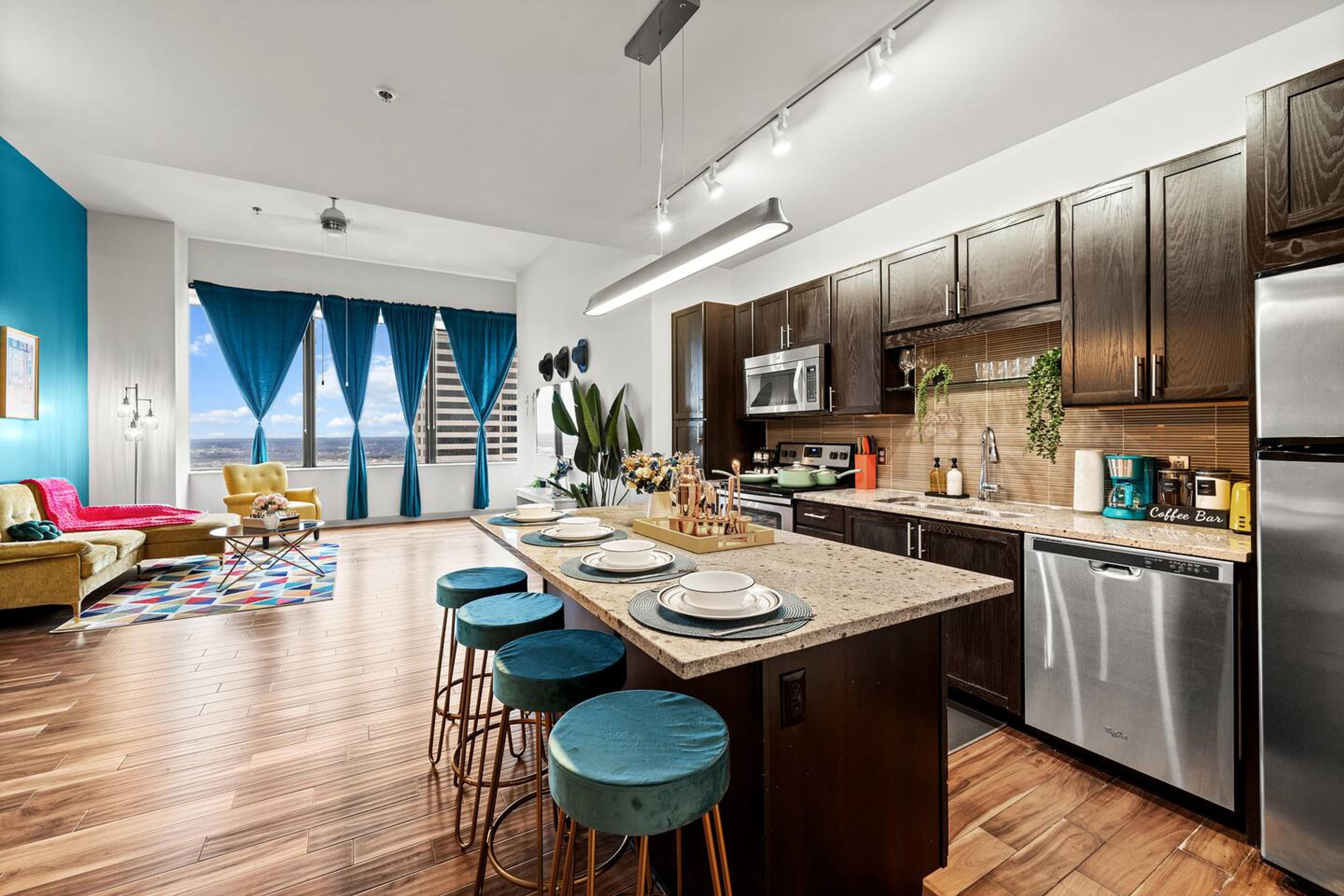 Living room with a view of our minimalistic kitchen space with a small cute dining setup!