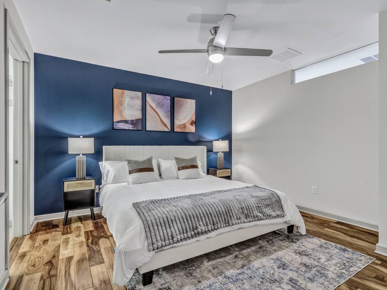 A Perfect cute spacious bedroom with one king bed that sleeps 2 adults. Designed with with comfort in mind and equipped with memory foam mattress, Cozy bedroom with nightstands, Pack N Play
