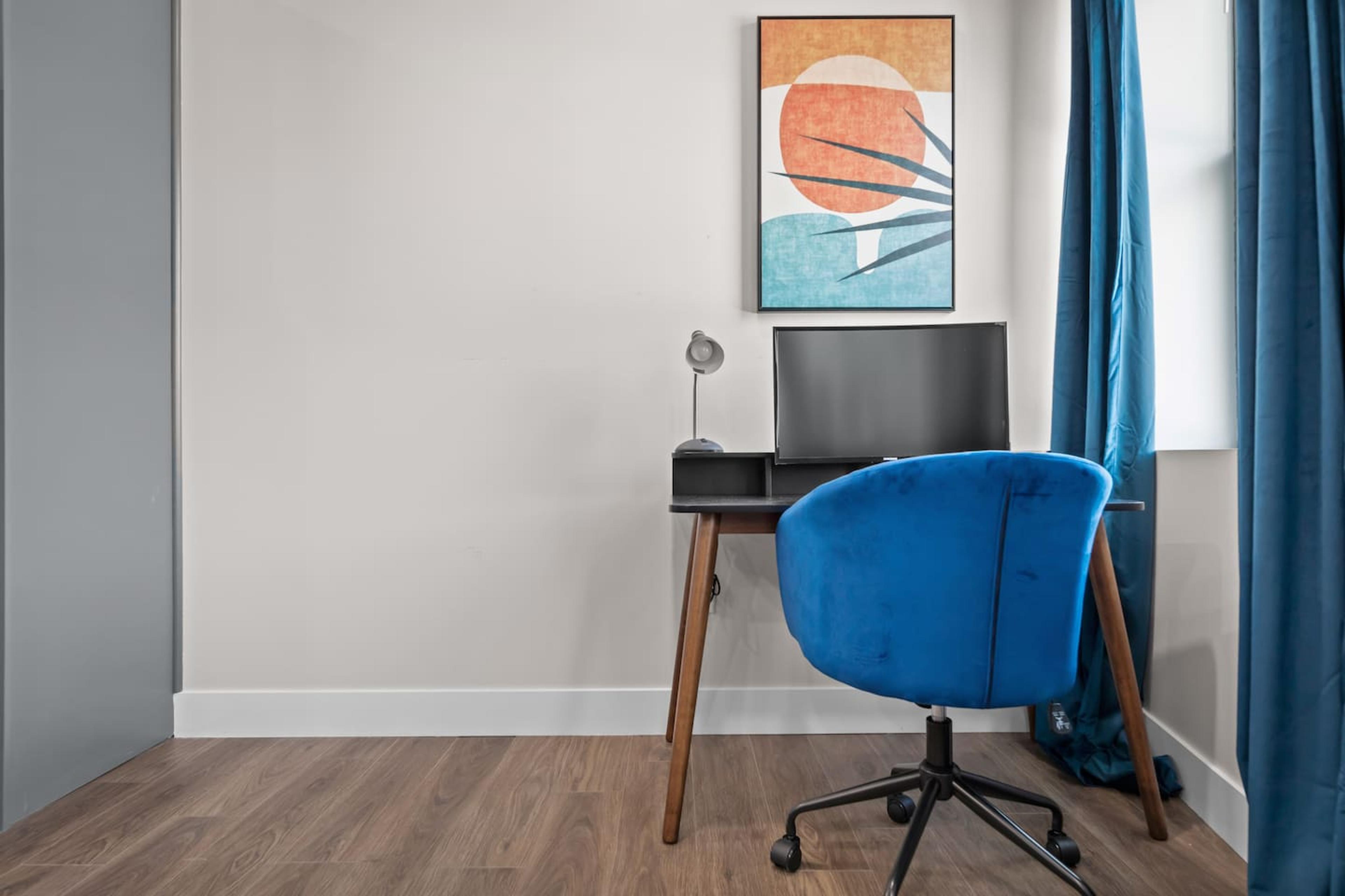 A workspace equipped with a table, chair, and monitor.
