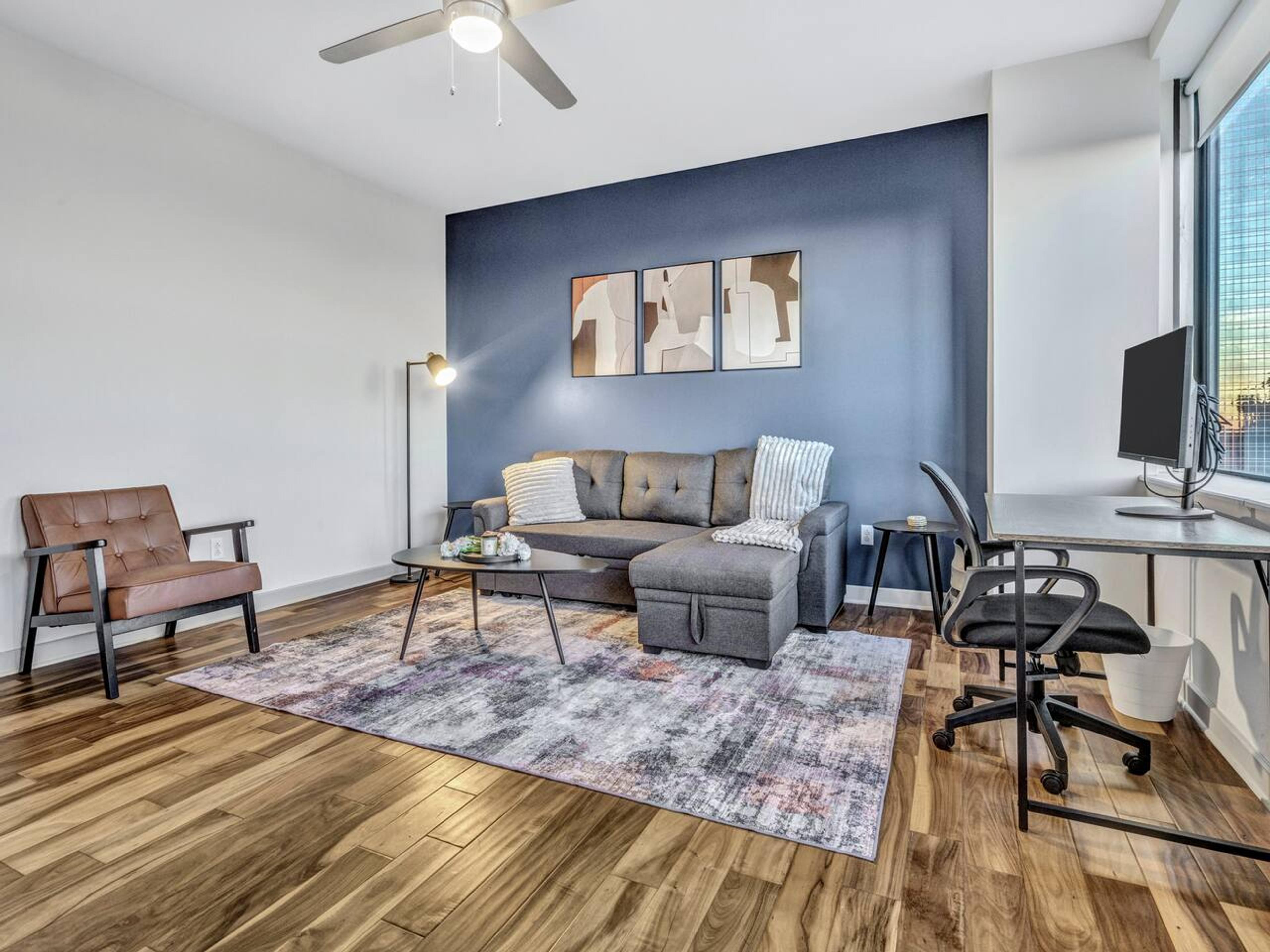 Living area : Experience the comfort and style with this brand new couch, TV, center table and a little work space with monitor.