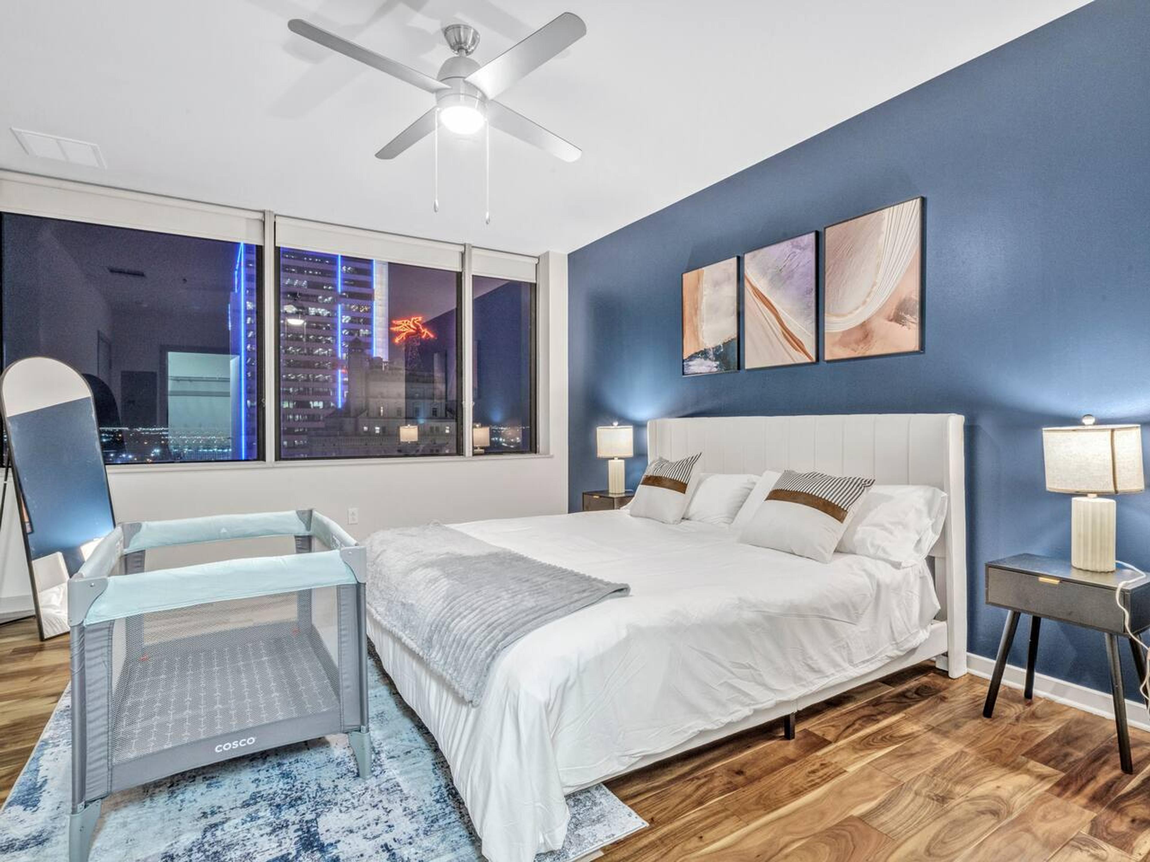 A Perfect cute spacious bedroom with one king bed that sleeps 2 adults. Designed with with comfort in mind and equipped with memory foam mattress, Cozy bedroom with nightstands, Pack N Play