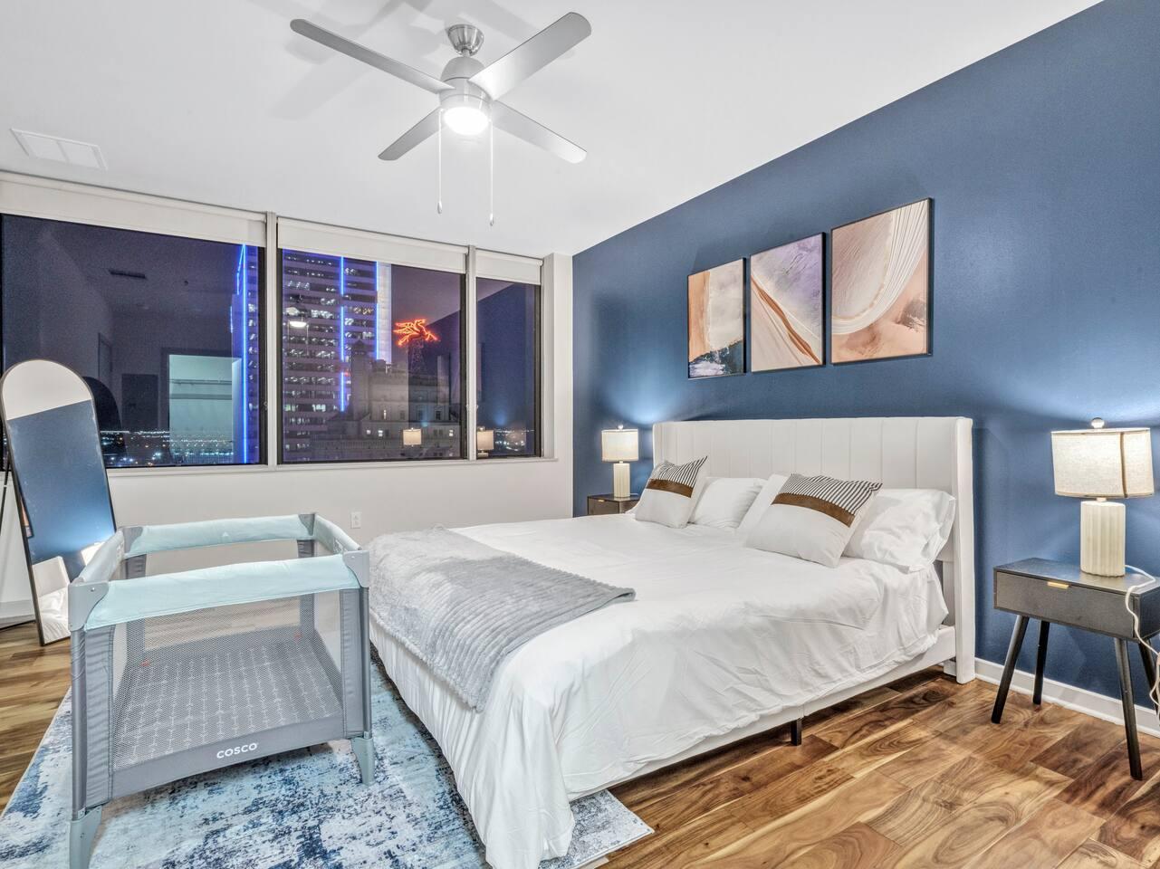 A Perfect cute spacious bedroom with one king bed that sleeps 2 adults. Designed with with comfort in mind and equipped with memory foam mattress, Cozy bedroom with nightstands, Pack N Play