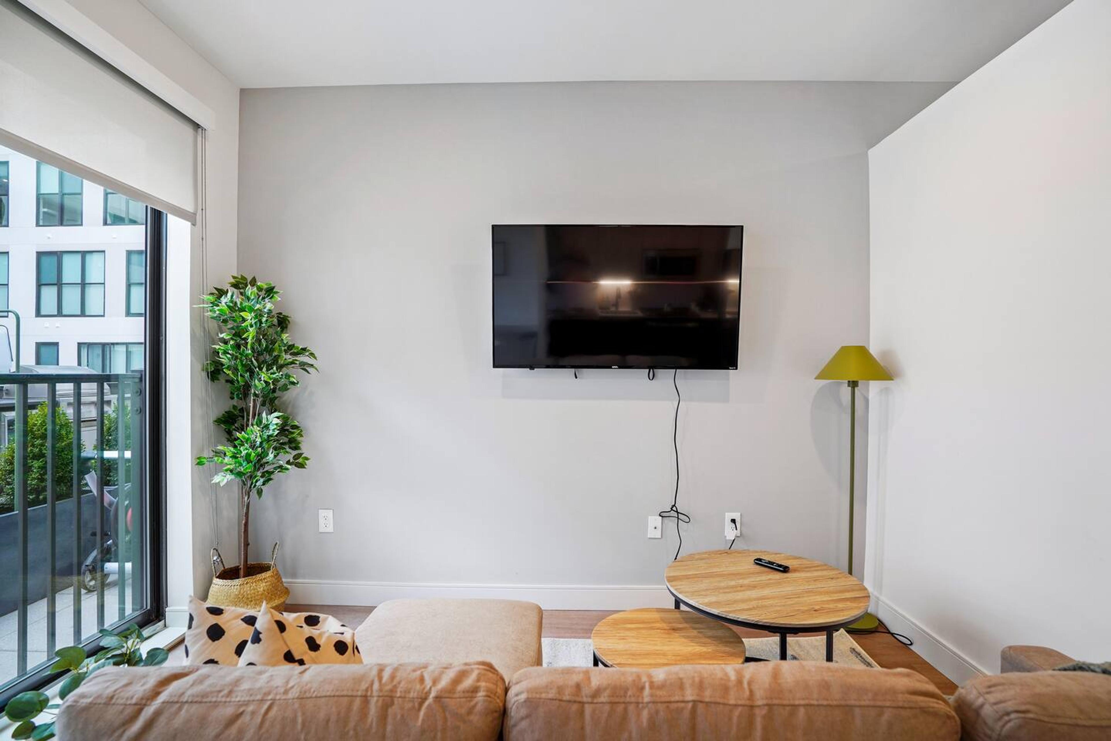 Living area Find Comfort, Convenience, and Immersive Viewing in this Living Area with Center Table,  50 inch TV and a Brand New Cozy Couch