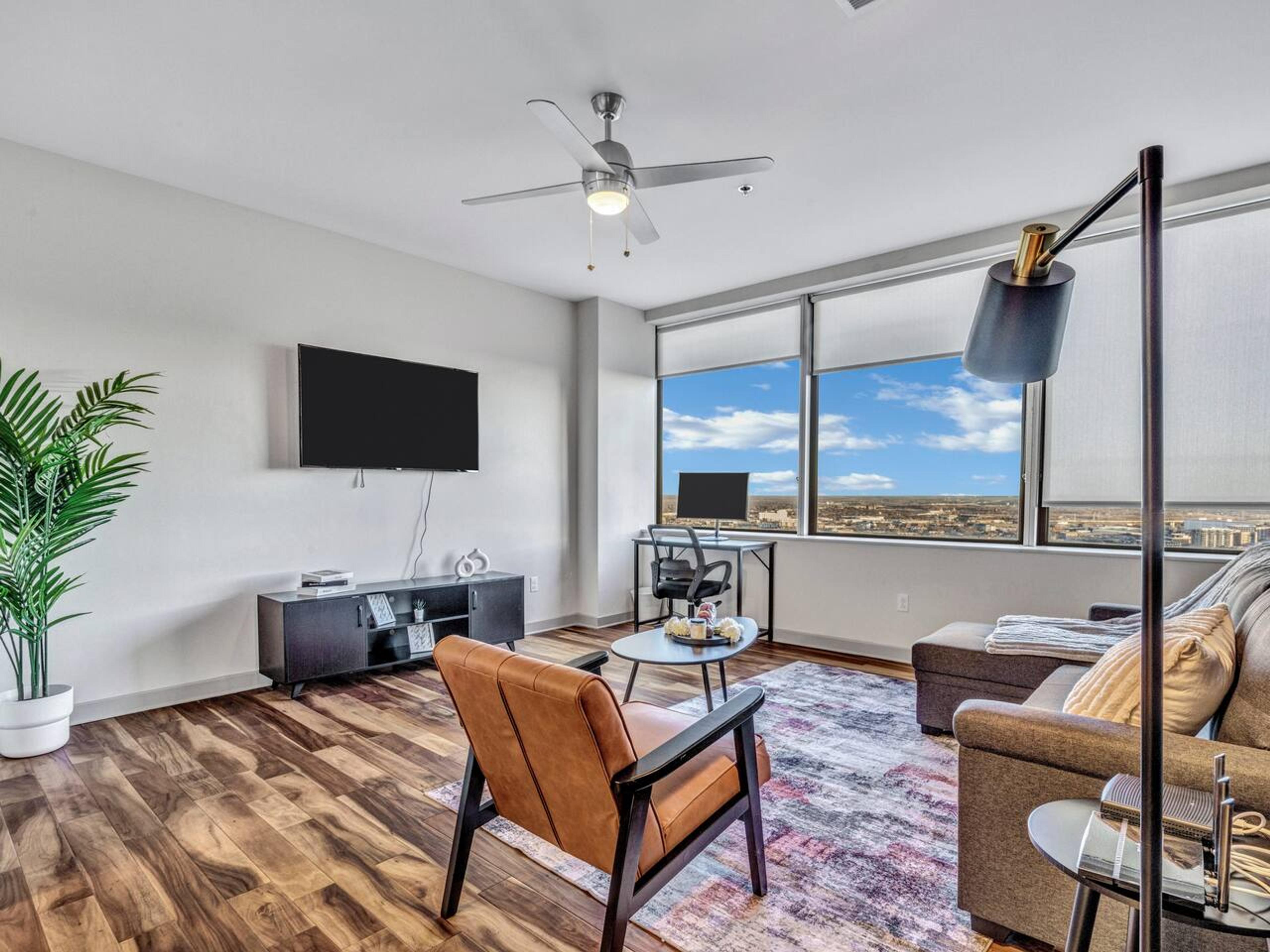 Spacious Living Room:  with couch, desk, office chair, monitor, TV and amazing city view