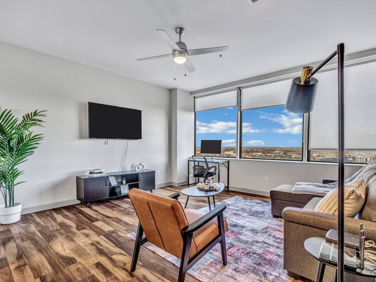 Spacious Living Room: with couch, desk, office chair, monitor, TV and amazing city view