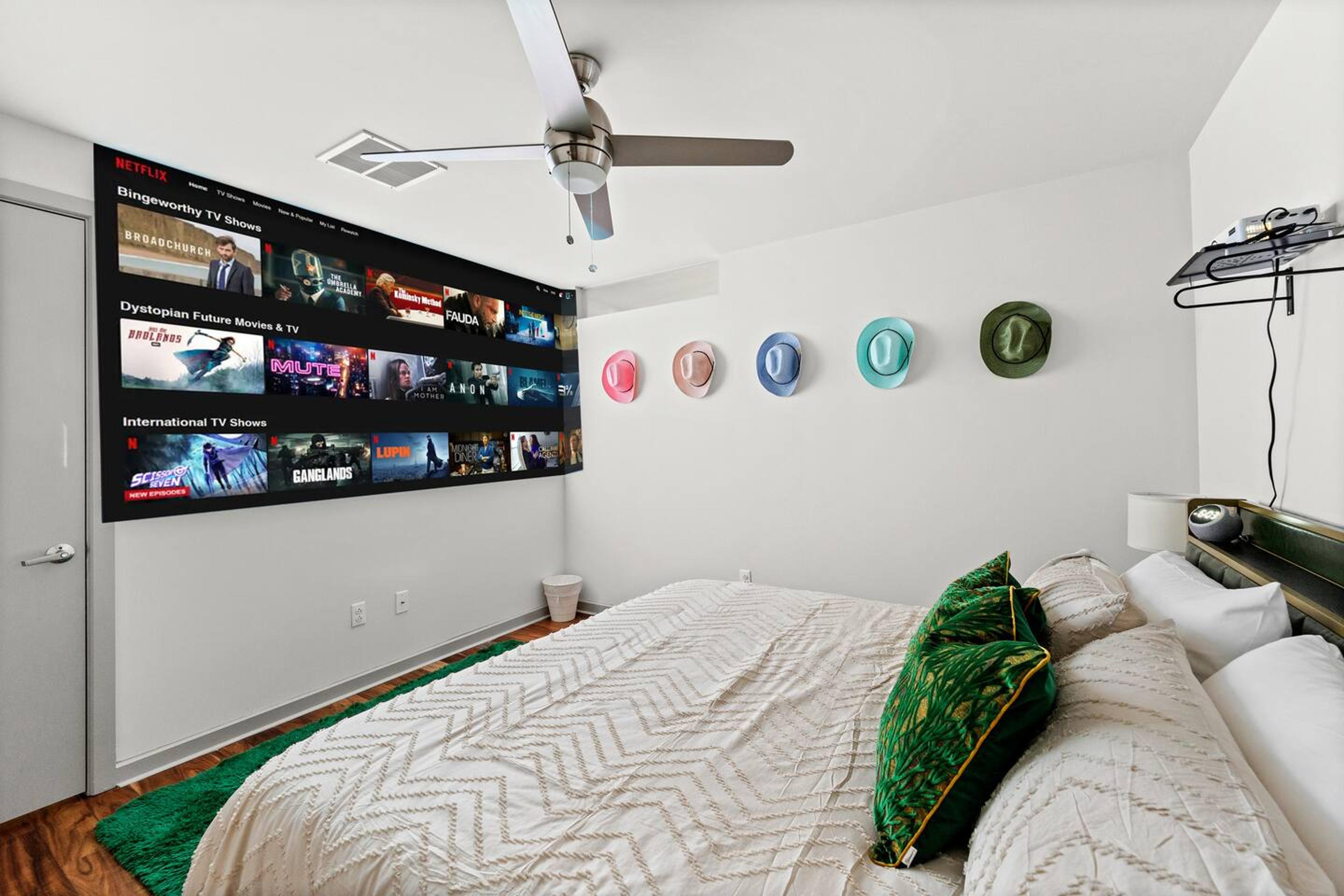 ️ Enjoy movie nights with the projector in this cozy bedroom featuring a plush king-size bed for ultimate comfort. ✨