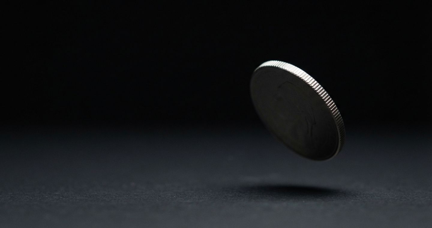 How Claude's watermark works — a coin mid-flip, the moment a free choice is settled