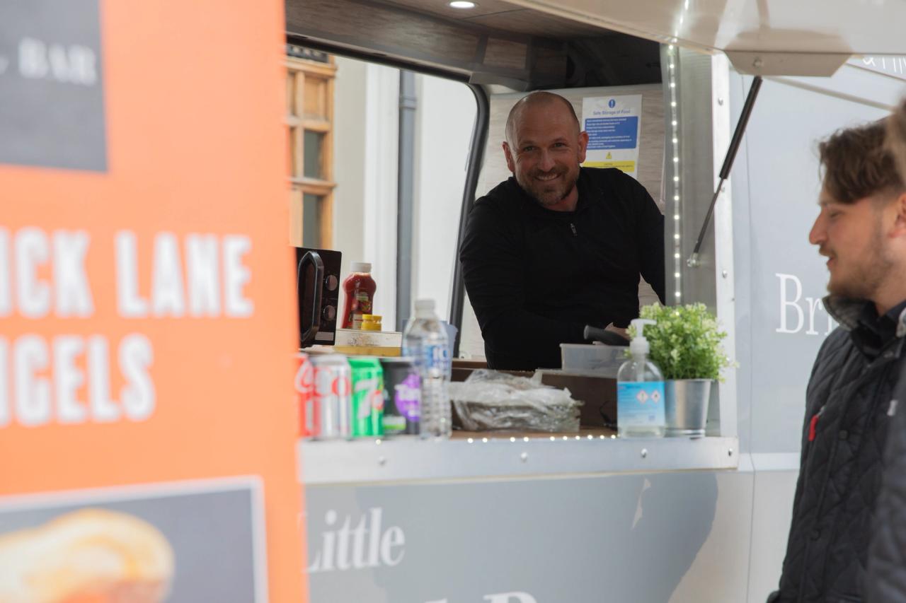 man looking through his bagel van hatch