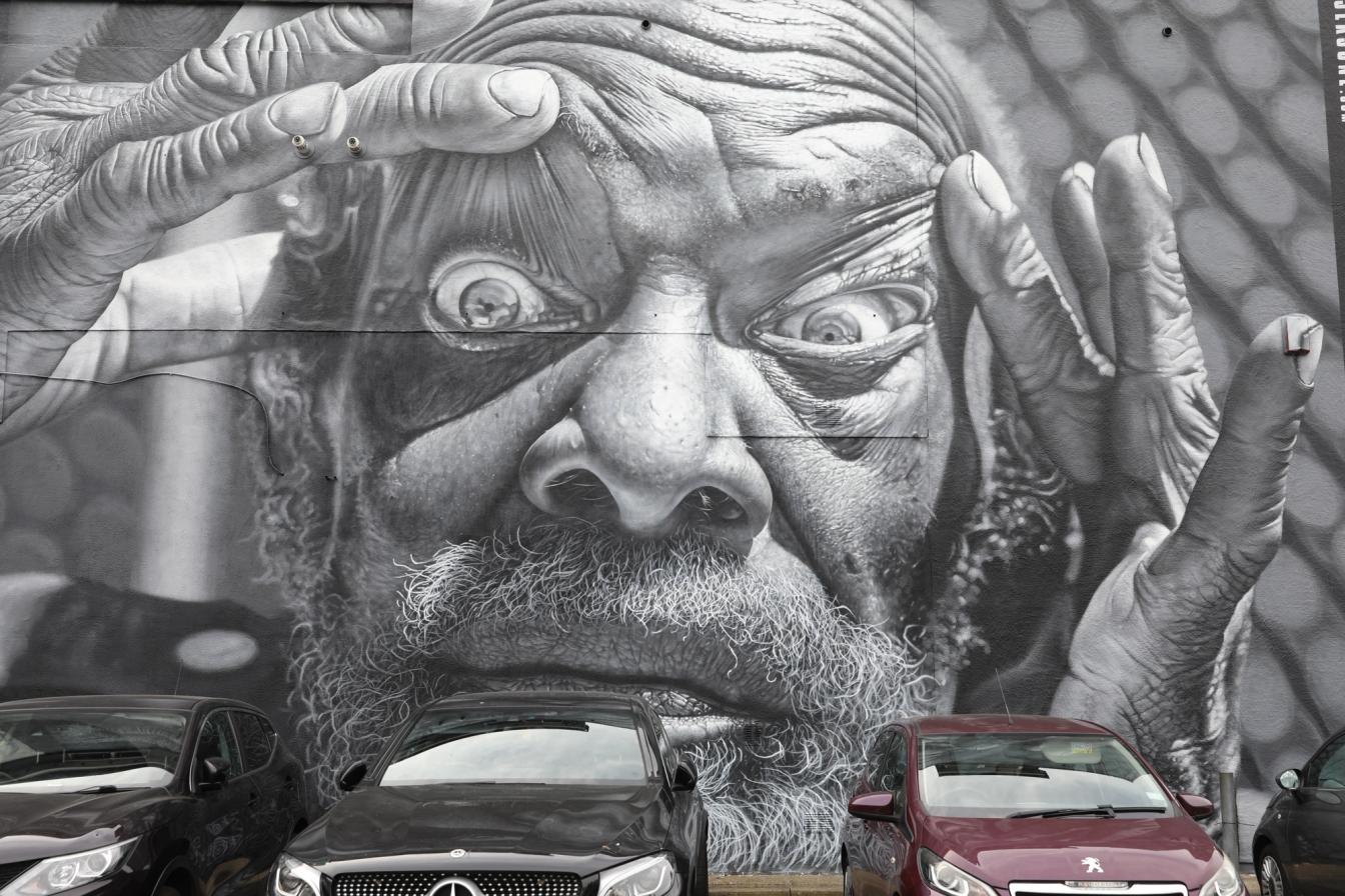 Mural in Southend of man holding his eyes open for Southend City Jam Mural in Southend of man holding his eyes open for Southend City Jam