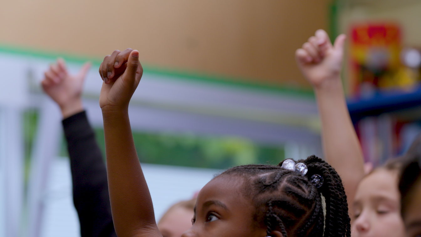 children with their hands in the air children with their hands in the air
