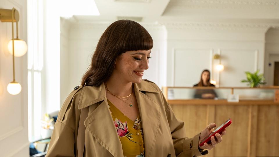 woman checking into hotel through her phone