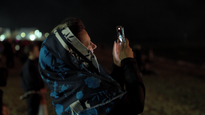 woman filming fireworks