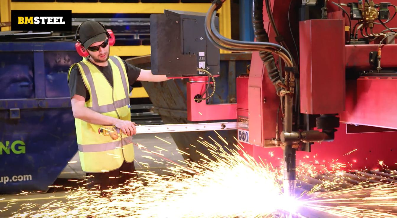 BM Steel team member operating machine with sparks flying BM Steel team member operating machine with sparks flying