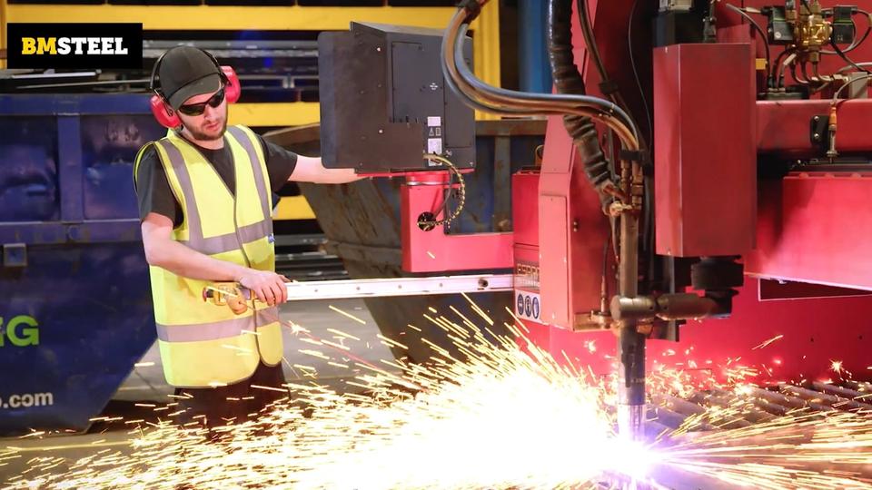 BM Steel team member operating machine with sparks flying