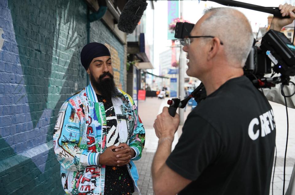 Camera Operator interviewing artist