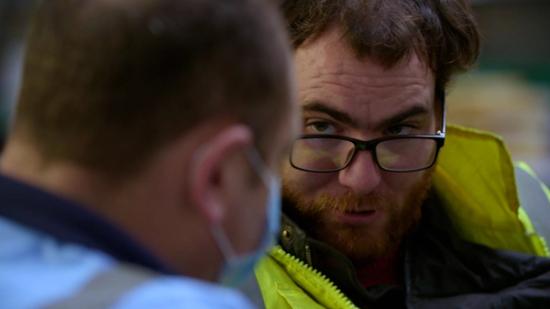 close up of man chatting to man wearing glasses 
