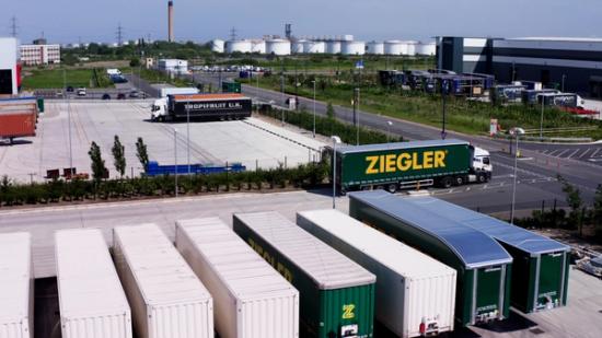 drone shot of logistics lorry leaving depot