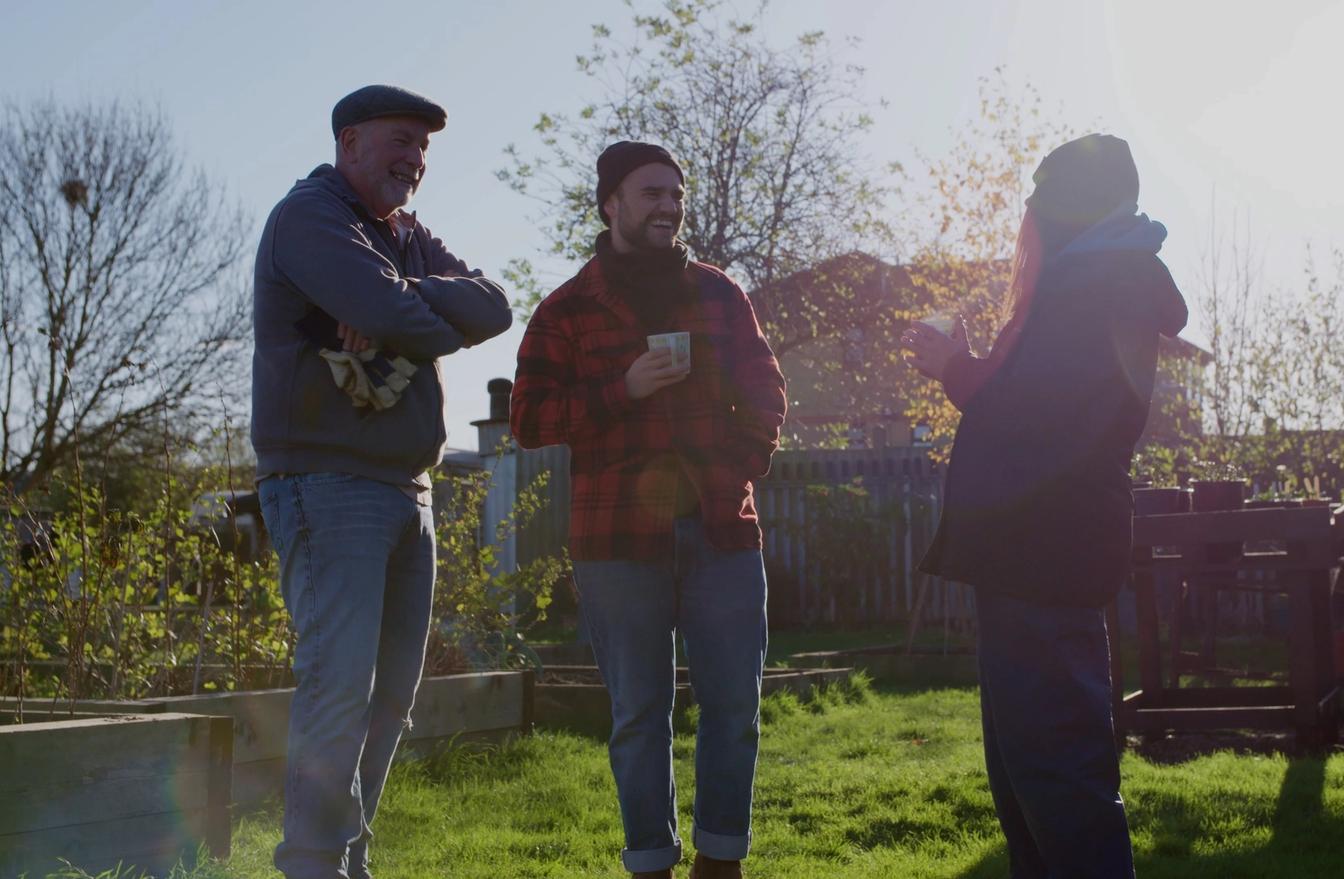 charity staff chatting in community garden