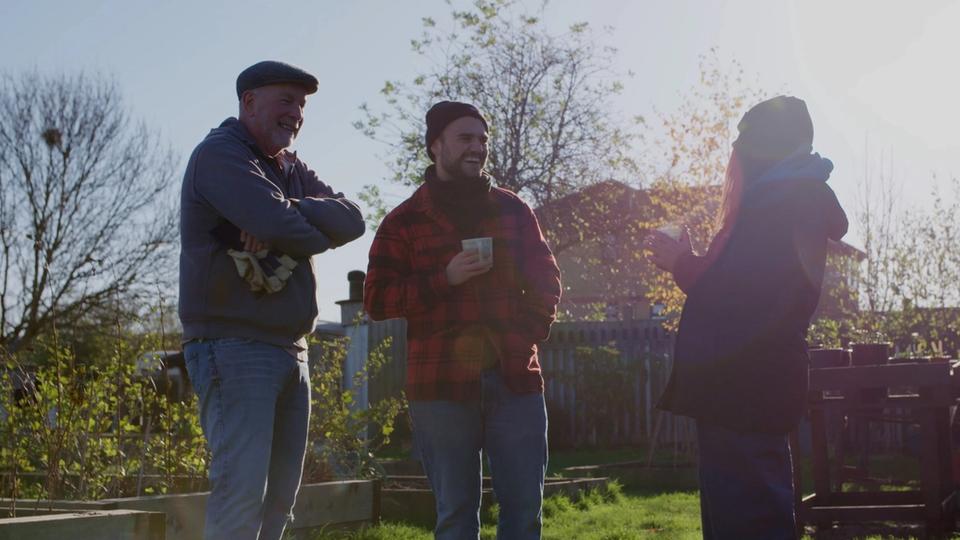 charity staff chatting in community garden