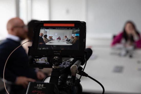 view of meeting scene through camera monitor 