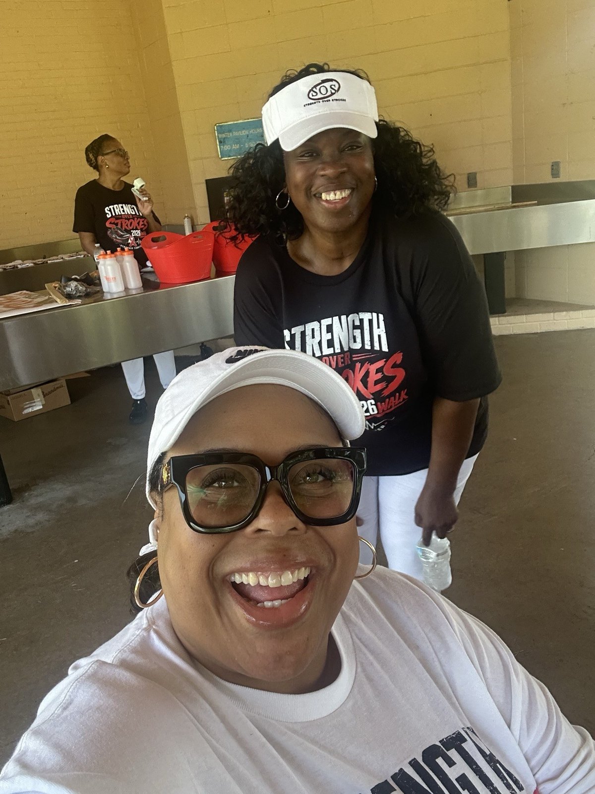 Tamika Scott smiling with a fellow participant at the Strength Over Strokes Walk.