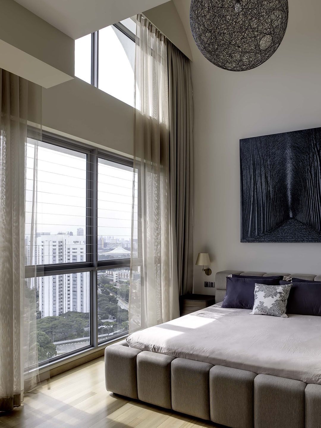 Motorised curtains in a bedroom with high ceiling in a Singapore condo apartment