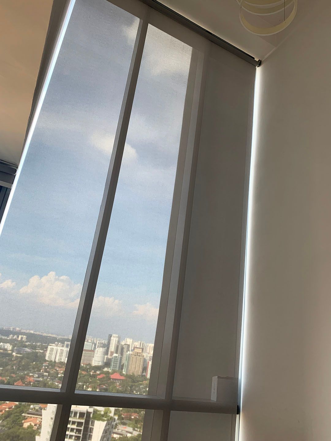 Motorised window blinds in an apartment with a high ceiling