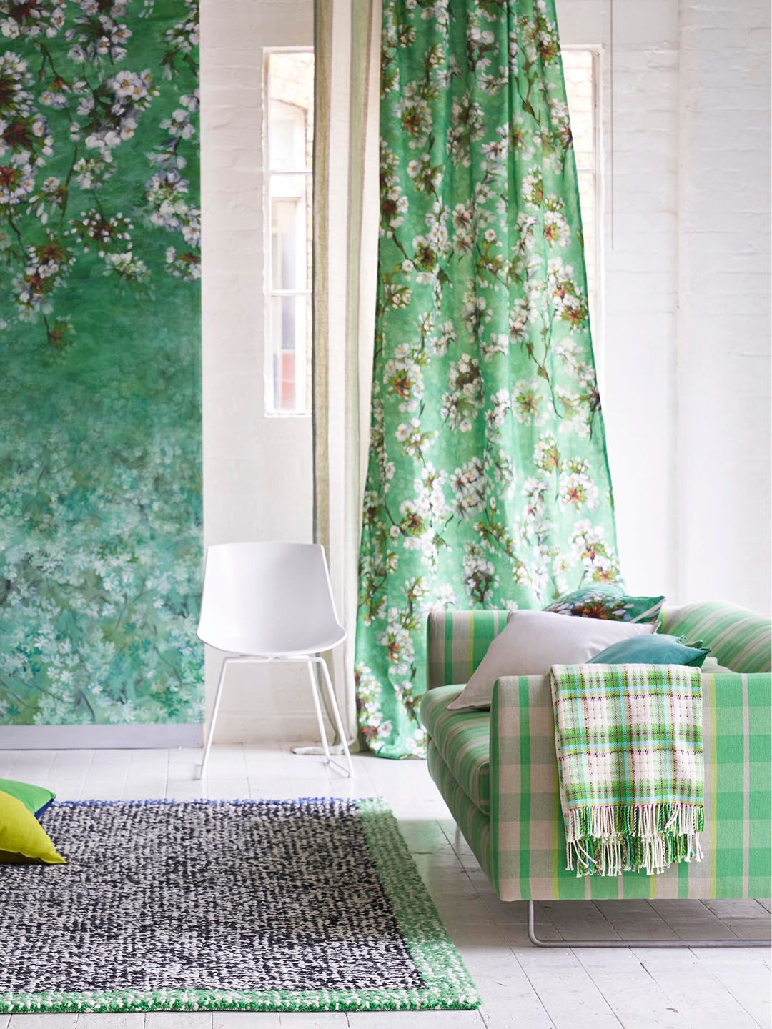 Bright living room with Designers Guild curtains, wallpaper and upholstery