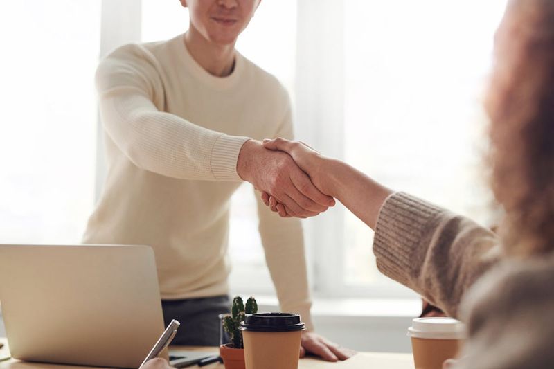 Two partners shaking hands after an agreement