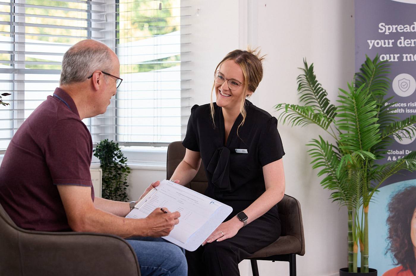 Receptionist explaining to treatment options to patient in Manchester
