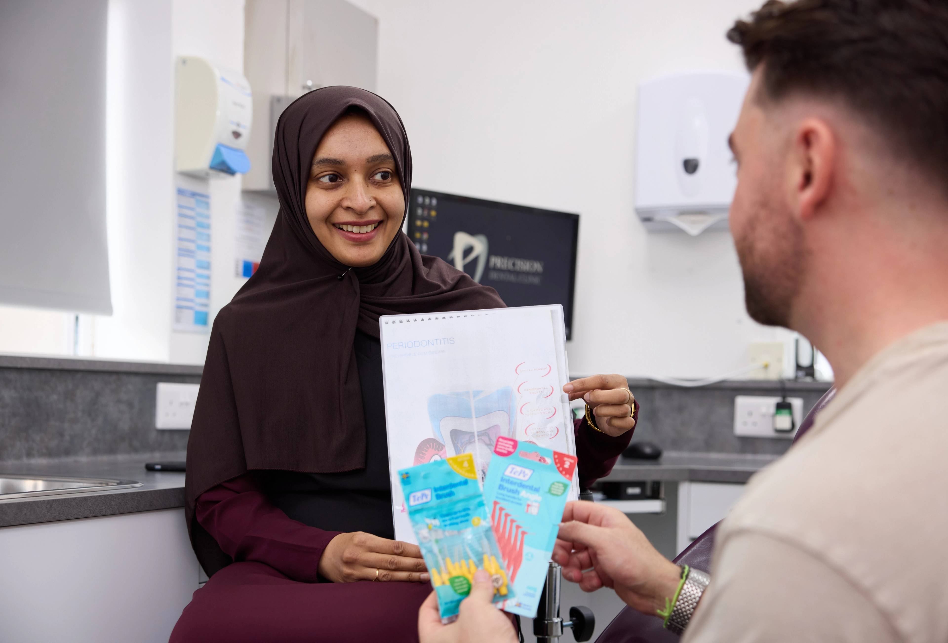 dentist talking to a patient about dental hygiene in a dental surgery