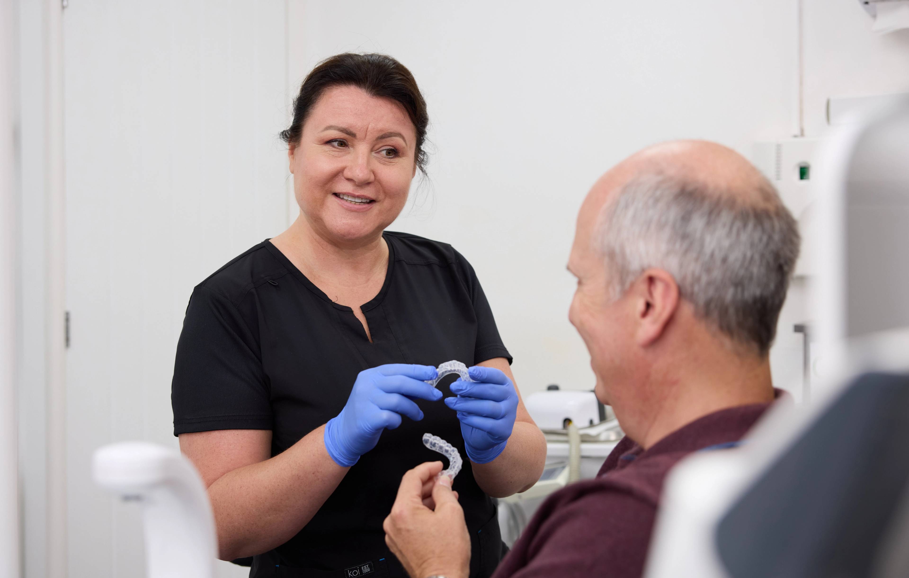 Dentist at Precision Dental Clinic talking to patient about finance options for cosmetic treatments