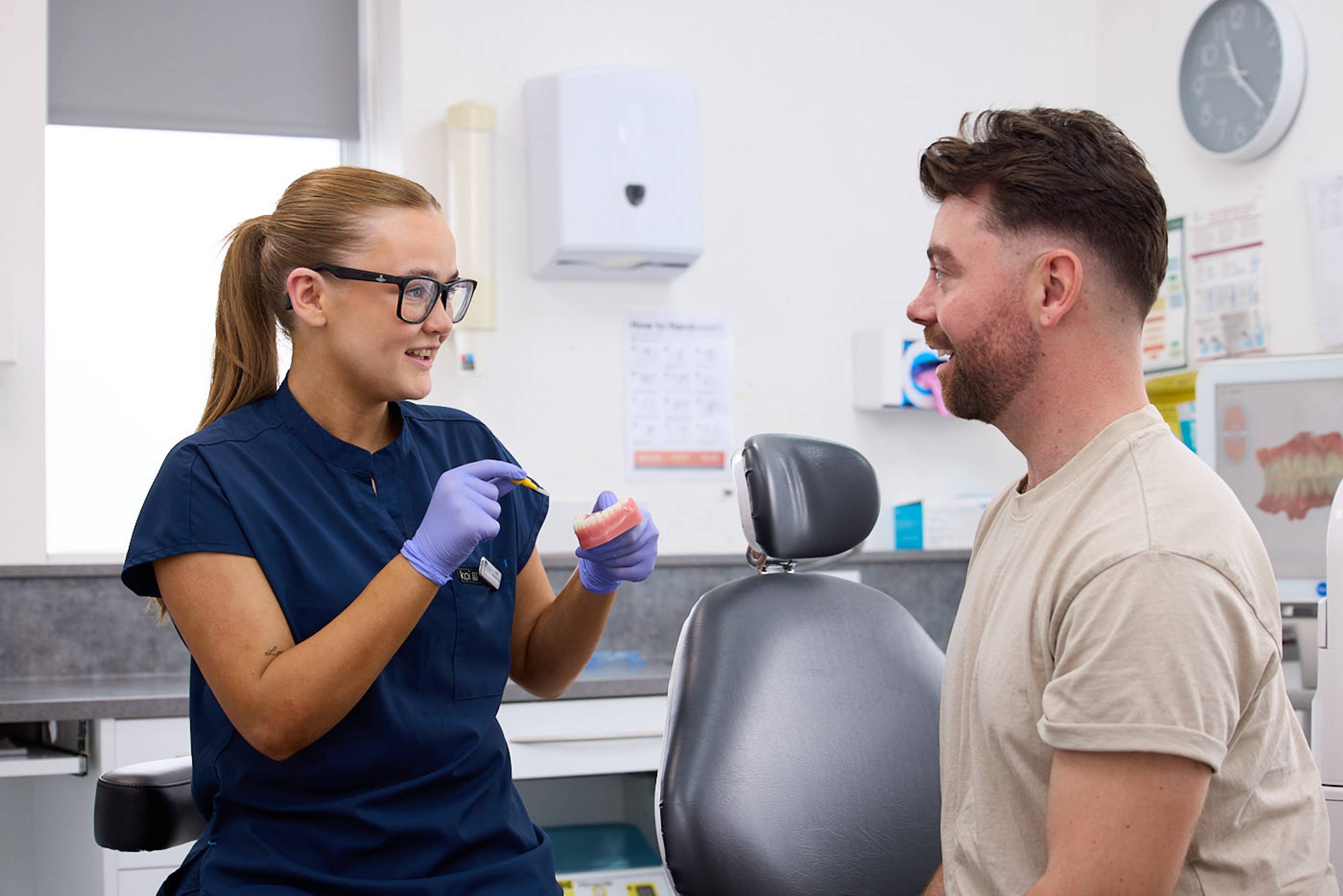dental nurse speaking to patient in nhs dental appointment