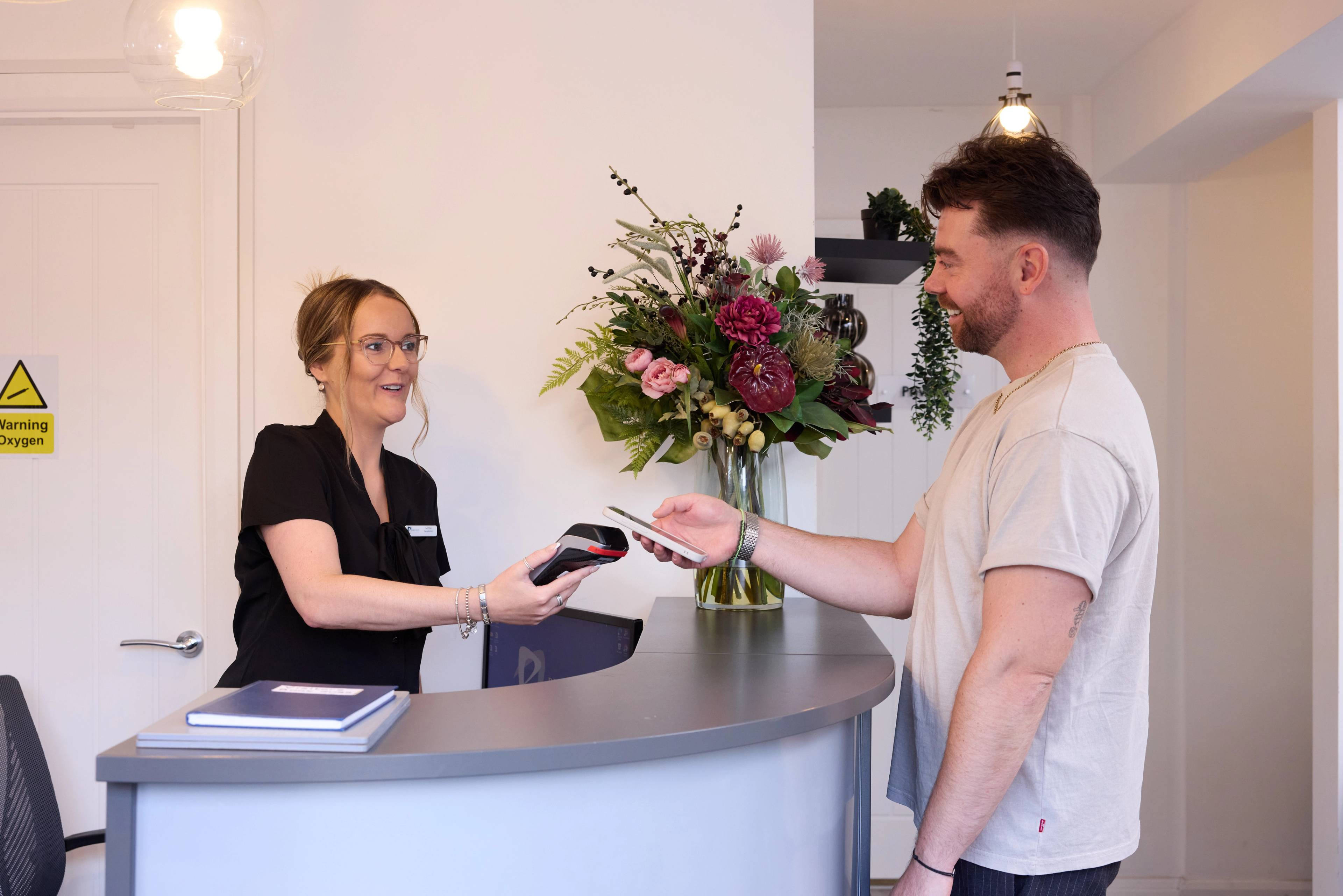 patient paying for treatment at dental practice in manchester