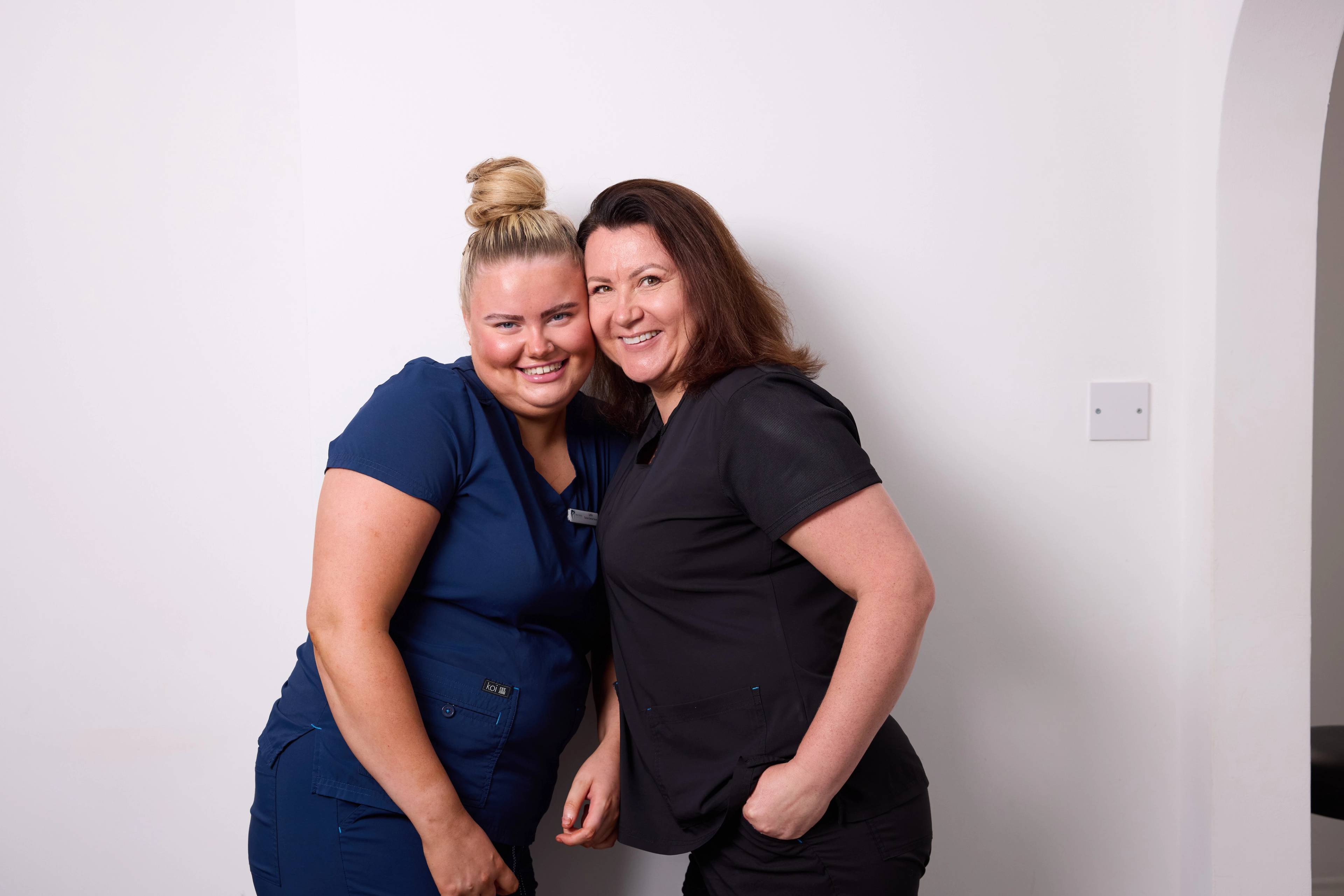 Precision Dental Clinic cosmetic dentist and nurse happy and smiling at camera