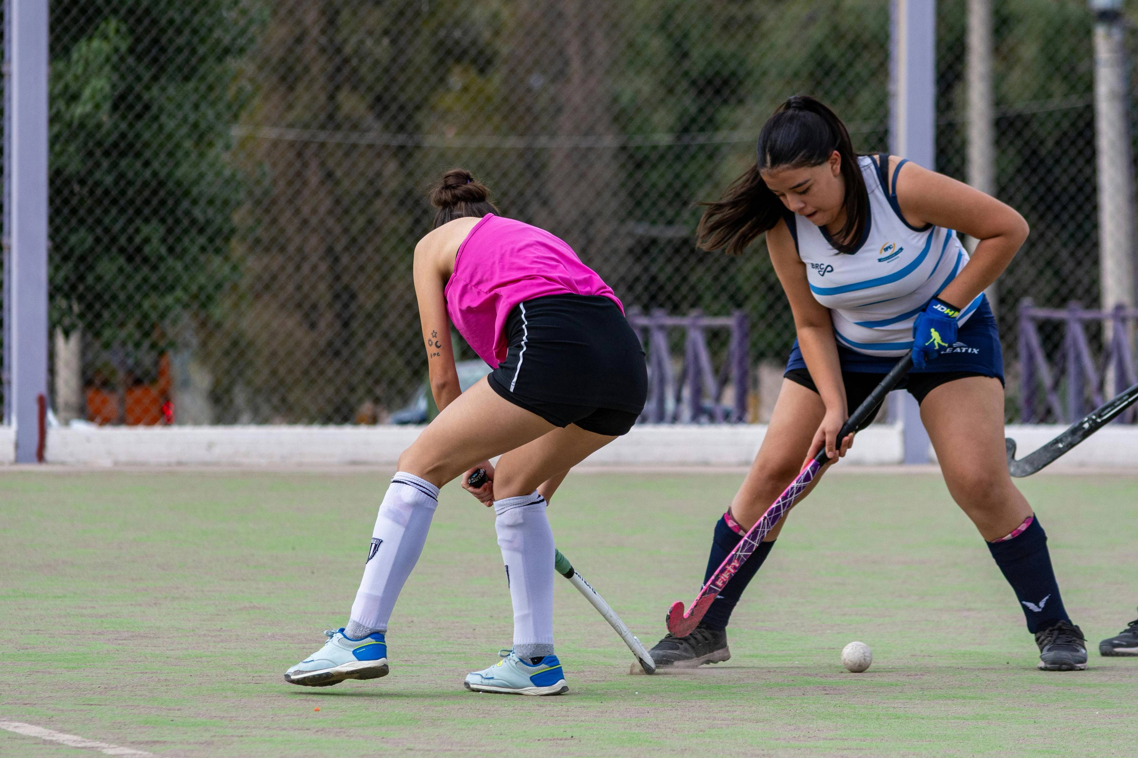 two female hockey players playing whilst wearing sport mouth guards gum shields