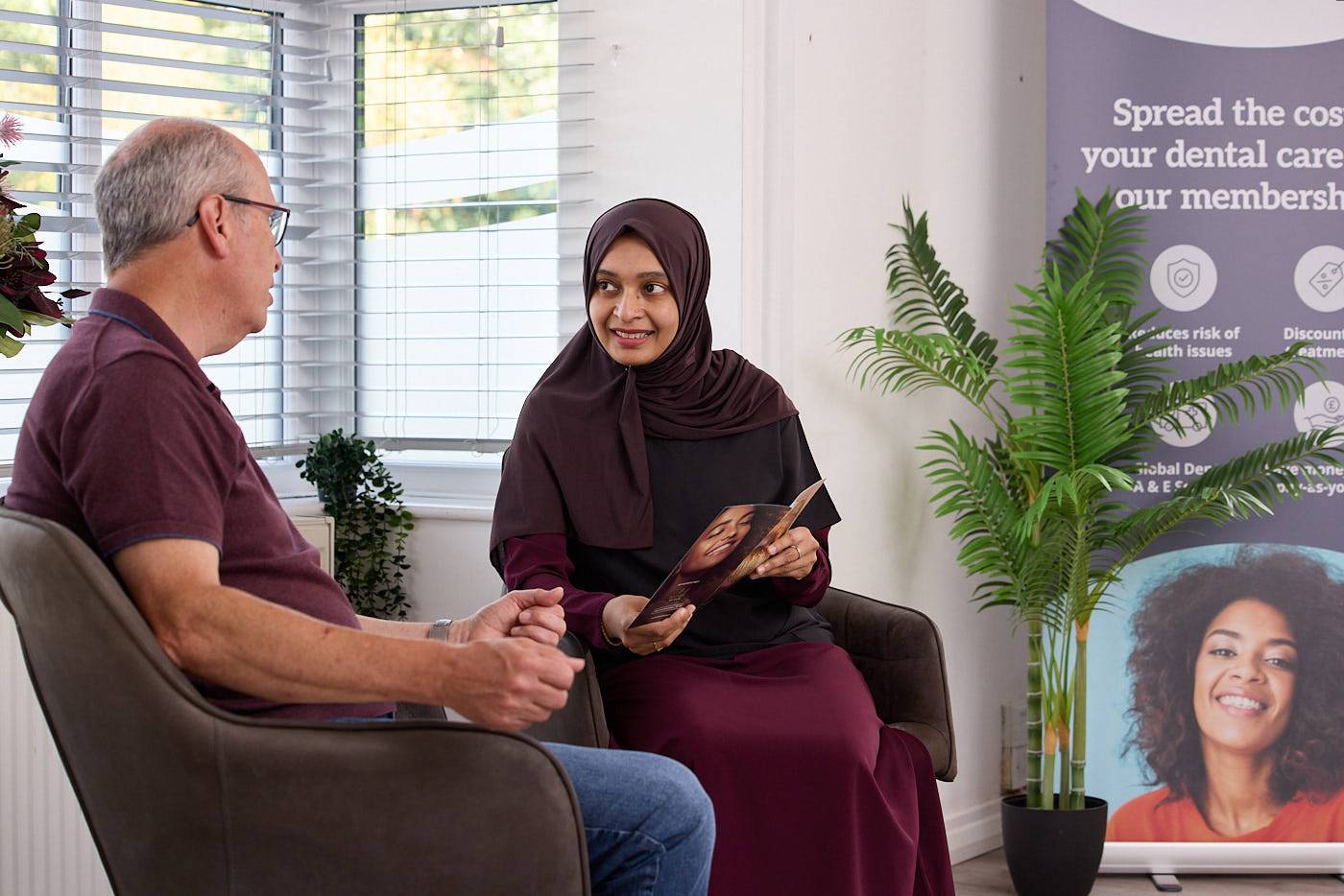 dentist talking to patient in waiting room about nhs dental care at Precision Dental Clinic