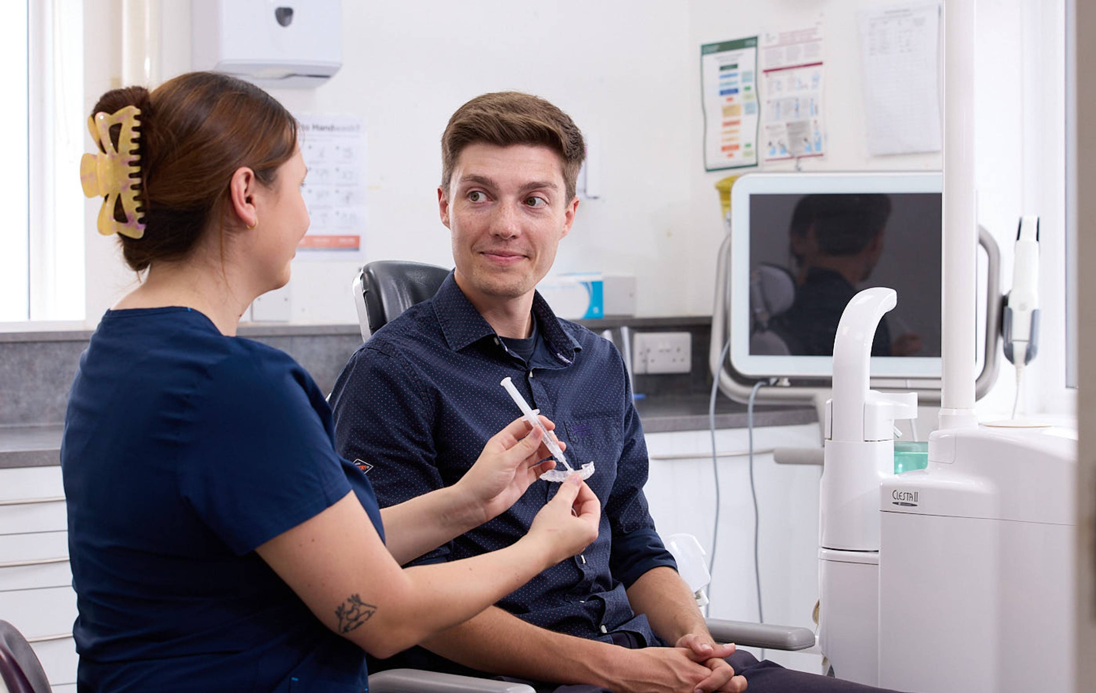 man smiling at cosmetic dental consultation in dental surgery