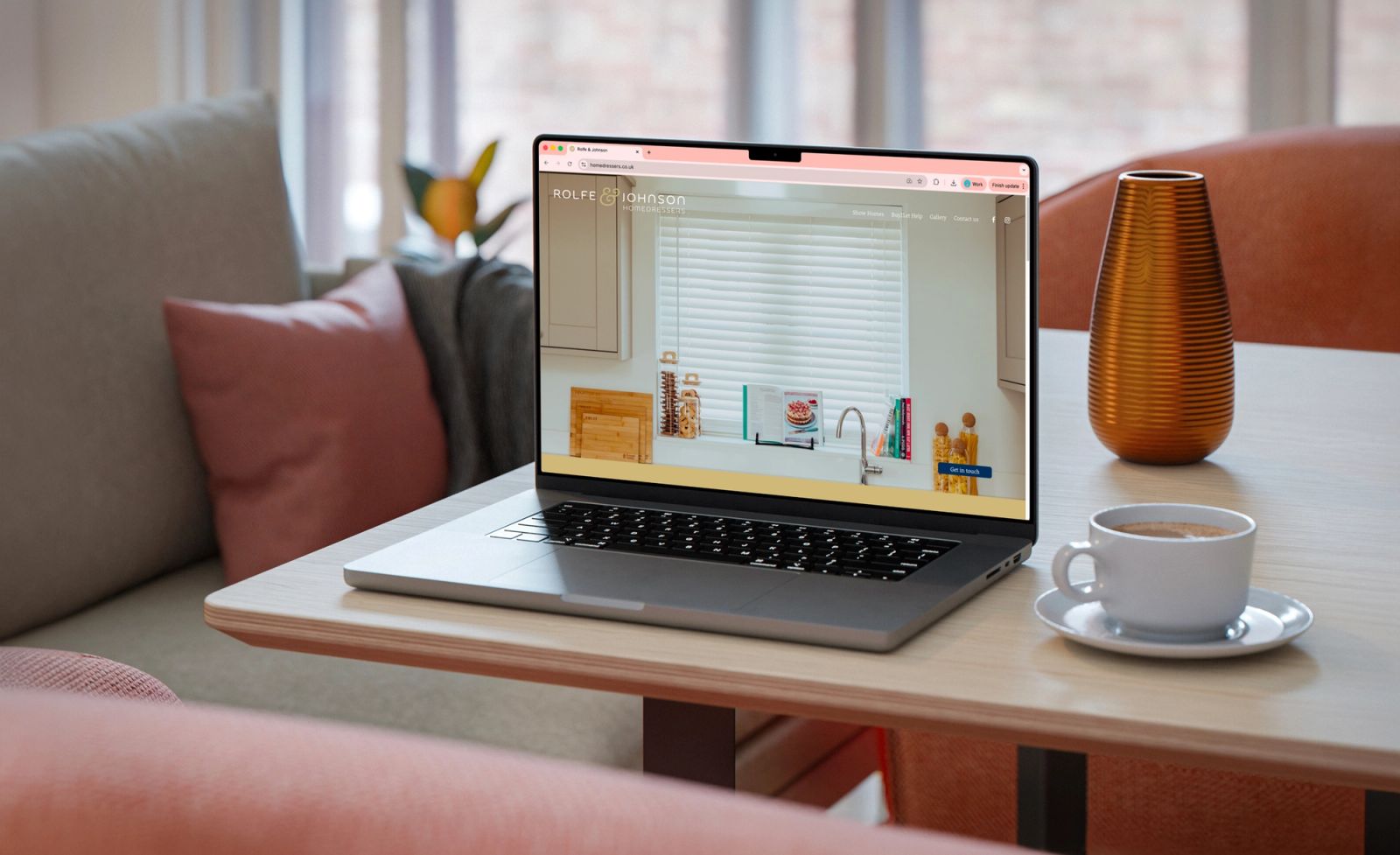 Rolfe & Johnson website mockup on coffee table
