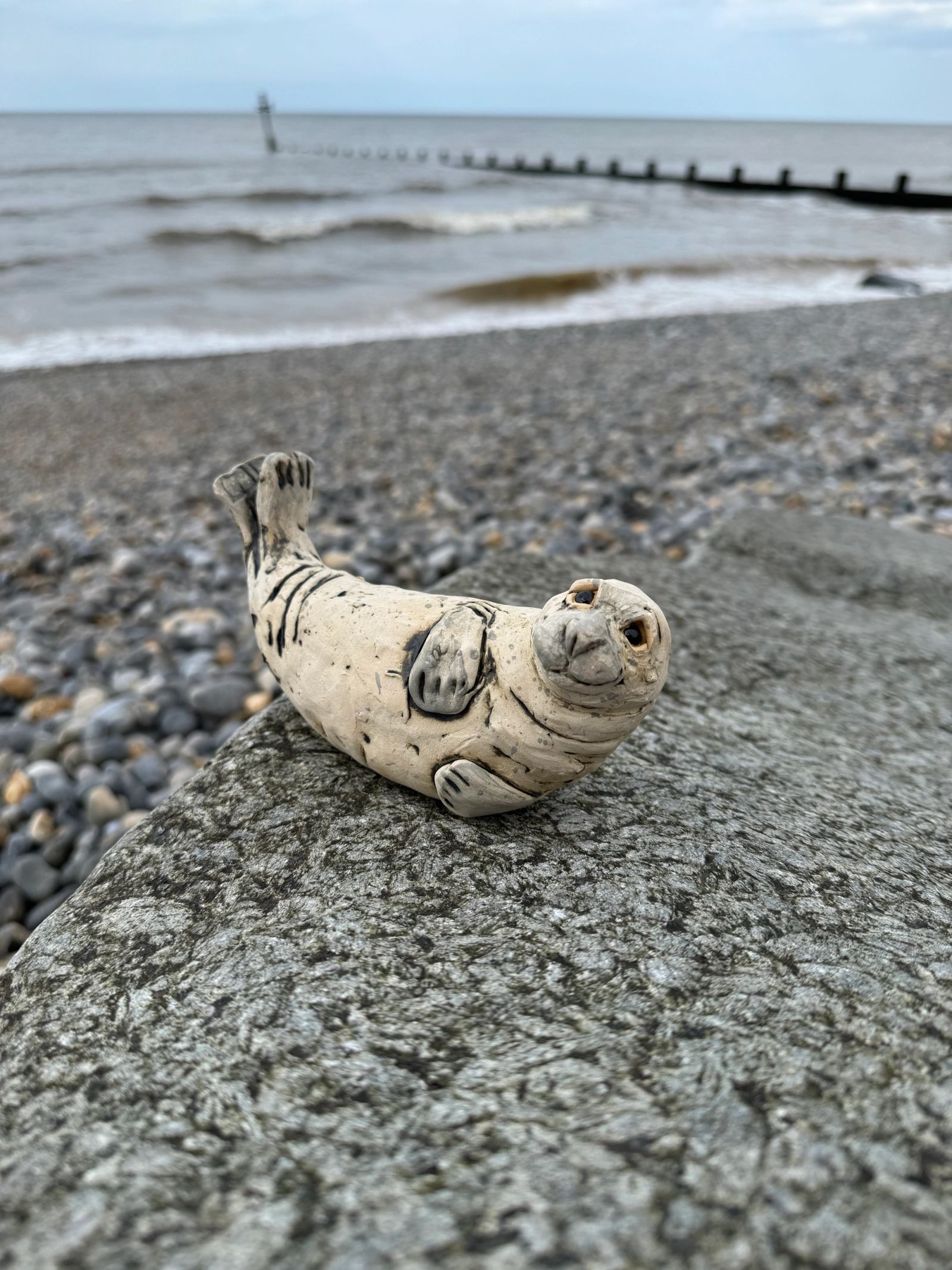 Seal ornament on beach gravel