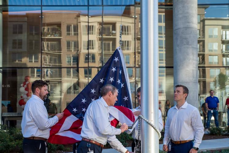 MRO Veterans raise the US flag.