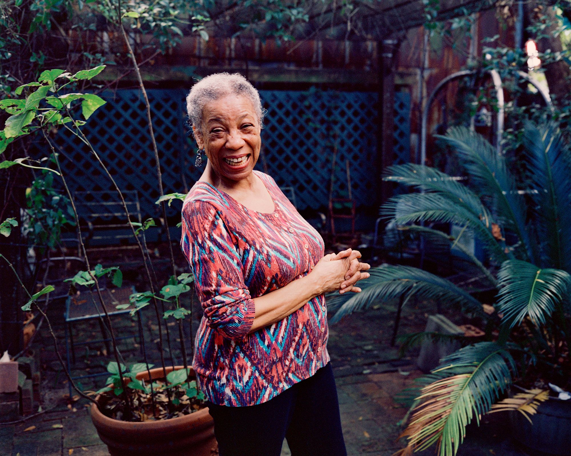 Suzanne Jackson standing in an outdoor garden patio