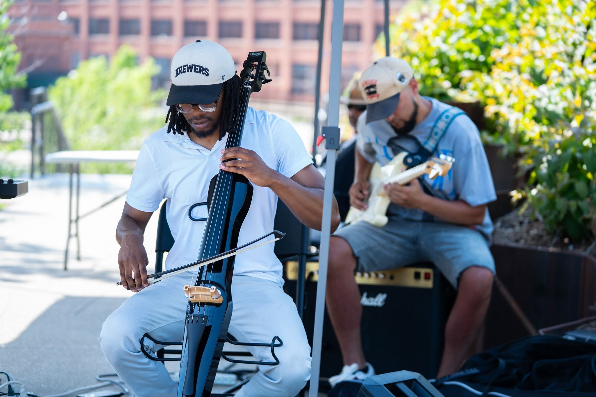 2 musicians onstage playing instruments.