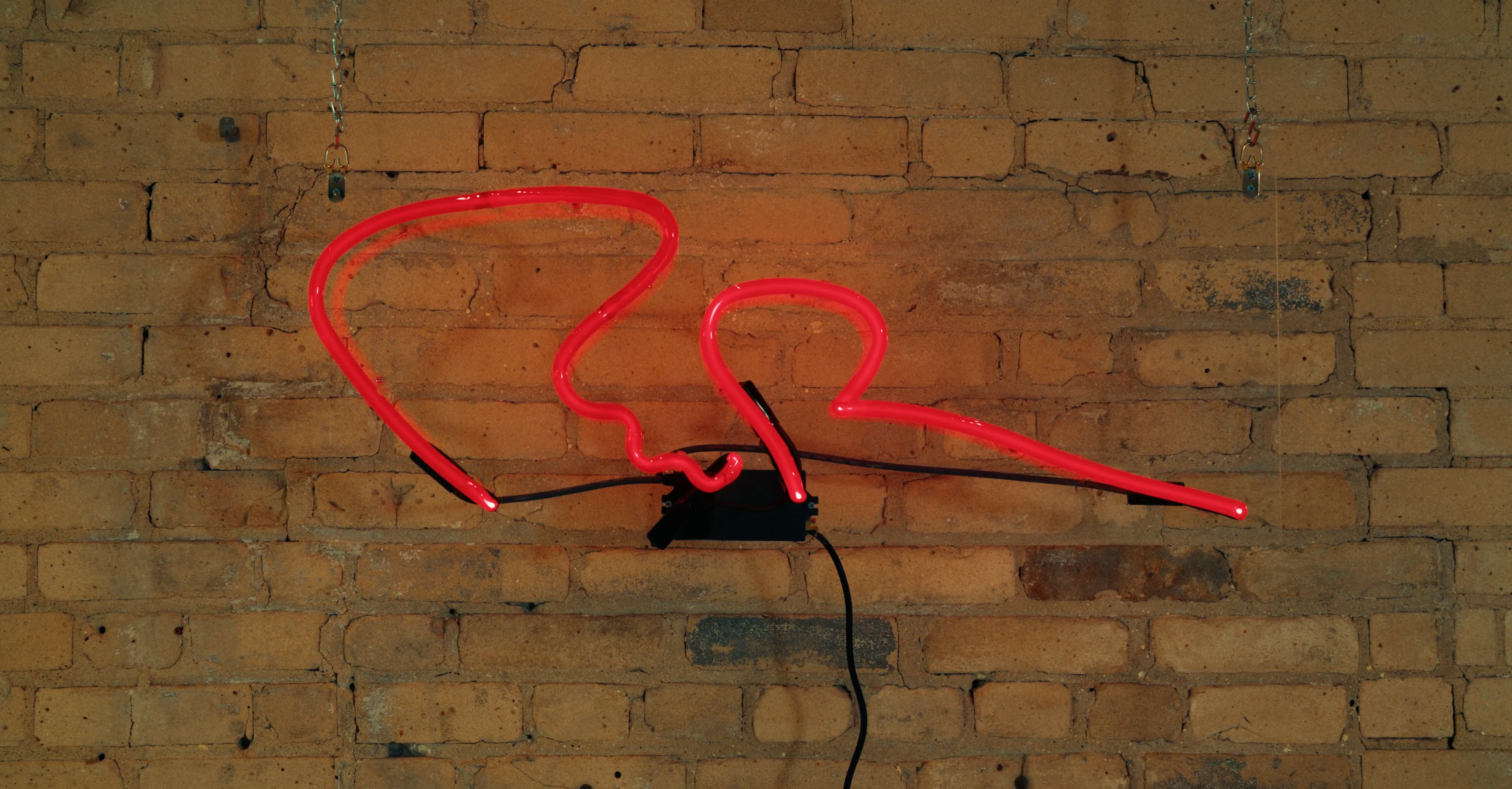 red neon sign inspired by the signature of Ruth DeYoung Kohler II