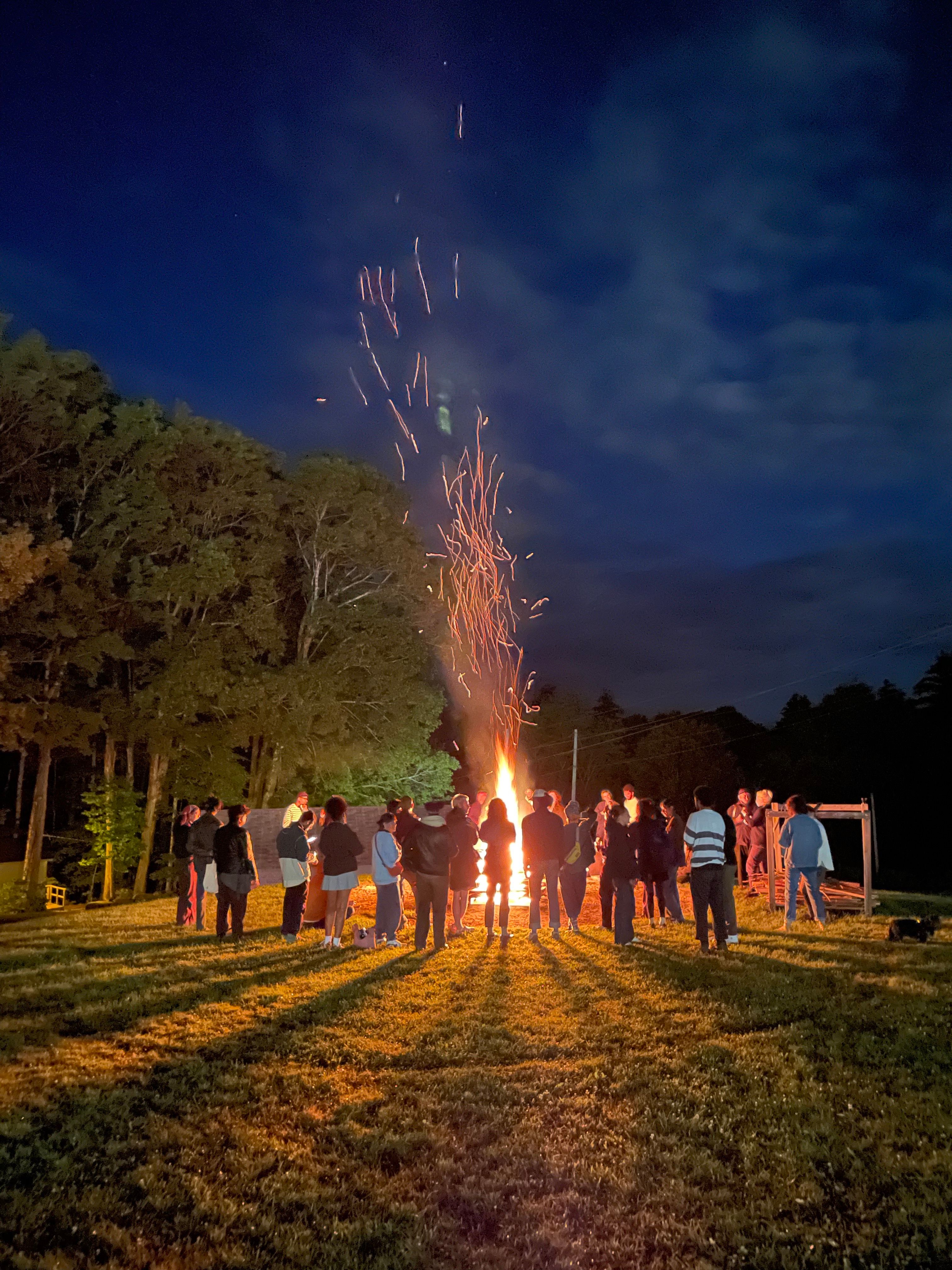 Residents gathered around a bonfire at Skowhegan 
