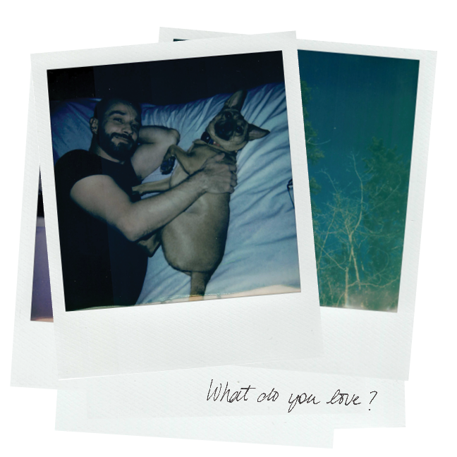 Polaroid photograph of a person and dog with a handwritten note that reads "What do you love?"